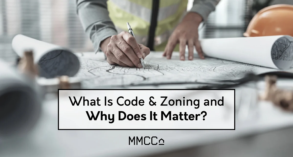 Hands marking up a set of rolled architectural drawings beside a hard hat, with the words "What Is Code & Zoning and Why Does It Matter?" set over it.